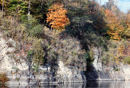 A steep river bluff with autumn color